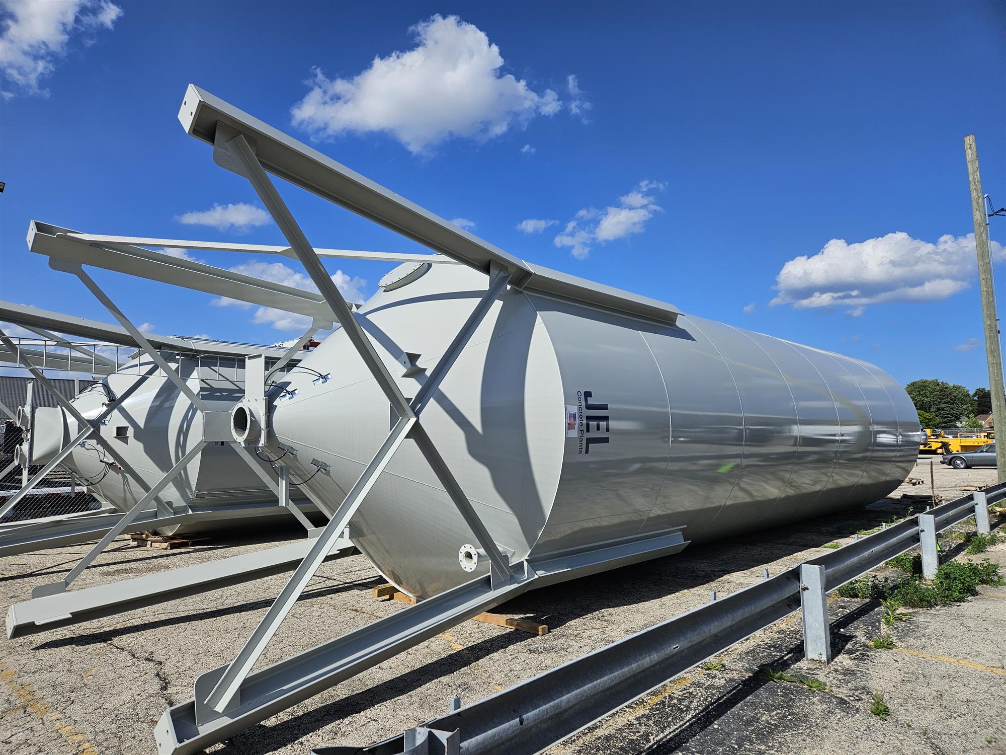 grey cement silos, blue sky