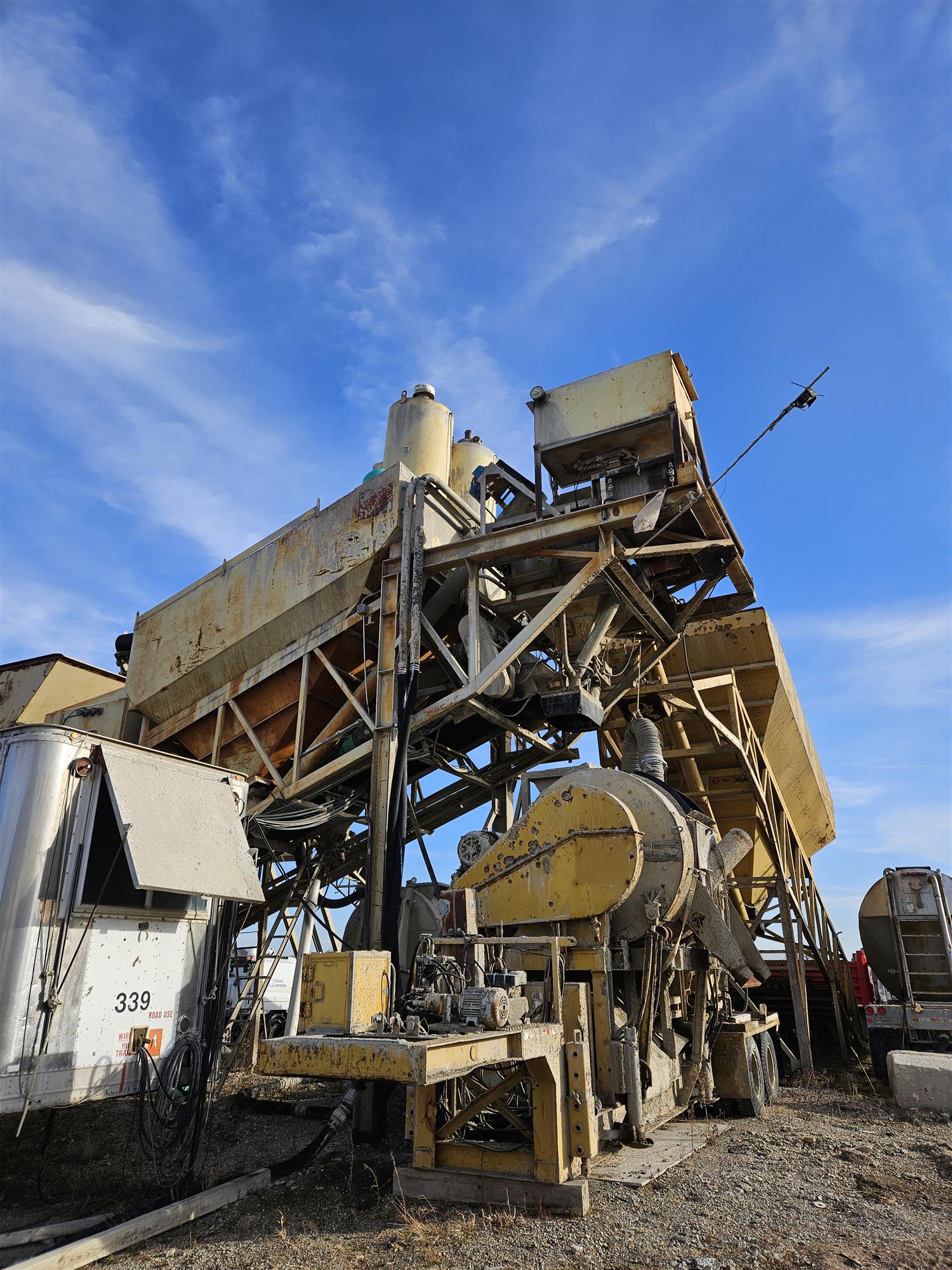 blue sky, industrial equipment, dead grass