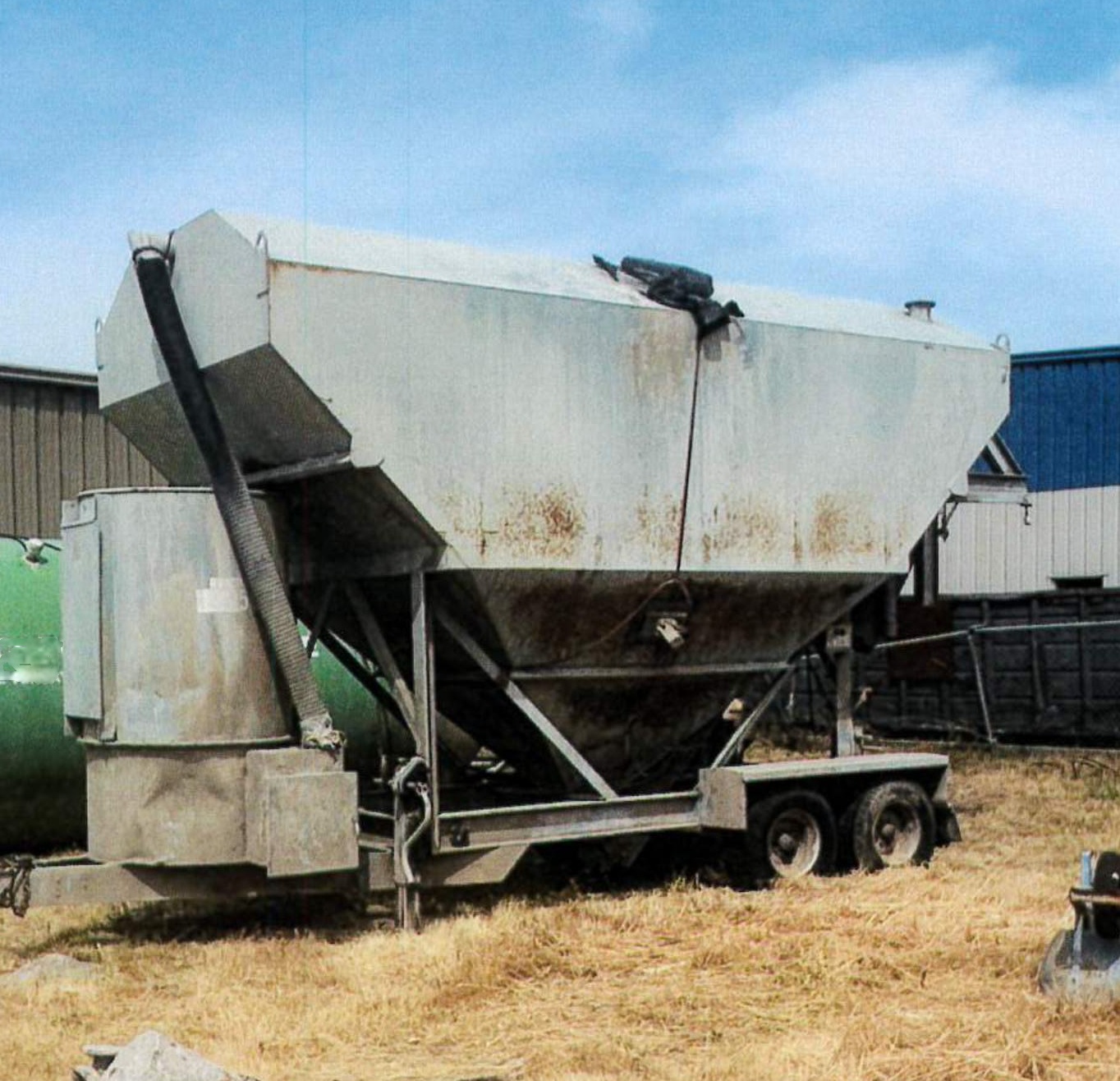 grey silo, brown grass, blue sky