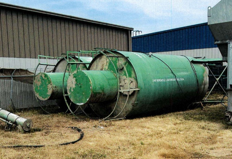 green silos, brown grass, tin buildings