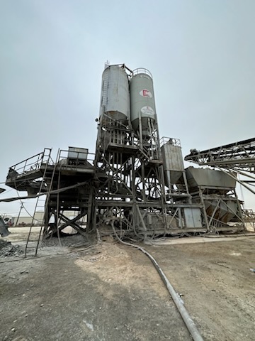 Erie Strayer portable central mix plant amongst grey sky and wet dirt